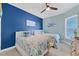 Bright bedroom with two beds, blue accent wall and tropical themed bedding at 396 Aruba Cir # 302, Bradenton, FL 34209