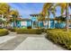 Exterior of the community clubhouse surrounded by lush landscaping and palm trees at 396 Aruba Cir # 302, Bradenton, FL 34209