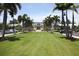 Exterior view of clubhouse with lawn, palm trees and parking area at 396 Aruba Cir # 302, Bradenton, FL 34209