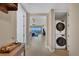 Hallway with a washer and dryer, leading to a living area with water views at 396 Aruba Cir # 302, Bradenton, FL 34209