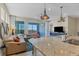 Open concept living room features a modern kitchen, comfortable seating, and water views at 396 Aruba Cir # 302, Bradenton, FL 34209