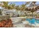 Outdoor picnic area with a gazebo and thatched umbrellas, tables, and well-maintained landscaping at 396 Aruba Cir # 302, Bradenton, FL 34209