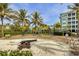 Community playground with slides, climbing structures, and a vintage cannon surrounded by palm trees at 396 Aruba Cir # 302, Bradenton, FL 34209