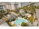 Aerial view of a community pool with lounge chairs and palm trees creating a relaxing oasis at 396 Aruba Cir # 302, Bradenton, FL 34209