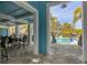 Shaded outdoor dining area overlooking a community pool with tables and chairs at 396 Aruba Cir # 302, Bradenton, FL 34209