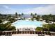 Gorgeous pool and outdoor lounge space with tropical landscaping and bay views at 396 Aruba Cir # 302, Bradenton, FL 34209
