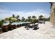 Beautiful community pool with ample seating, lush landscaping, and water views at 396 Aruba Cir # 302, Bradenton, FL 34209