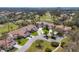Aerial view of golf course community featuring lush greenery and serene water features with red tile roofs at 4416 Calle Serena, Sarasota, FL 34238