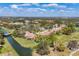 Expansive aerial view of a residential community featuring single-Gathering homes with red-tiled roofs, golf course, and green landscaping at 4416 Calle Serena, Sarasota, FL 34238