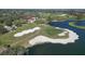 Scenic aerial view of the golf course with a club house and lush surroundings at 4416 Calle Serena, Sarasota, FL 34238
