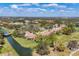 Expansive aerial view of a residential community featuring single-Gathering homes with red-tiled roofs, golf course, and green landscaping at 4416 Calle Serena, Sarasota, FL 34238