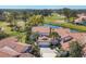 Beautiful aerial view of a residential area with golf course views and well-manicured landscaping and red tile roofs at 4416 Calle Serena, Sarasota, FL 34238