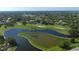 Panoramic aerial view of the lush community with homes, golf course and multiple ponds at 4416 Calle Serena, Sarasota, FL 34238