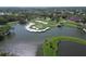 Stunning aerial view of a golf course with a lake and manicured greens in a serene landscape at 4416 Calle Serena, Sarasota, FL 34238