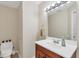 A half bathroom featuring a white vanity with stainless fixtures, and an elongated toilet at 4416 Calle Serena, Sarasota, FL 34238