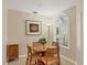 Cozy breakfast nook with a round table, four chairs, and a large window with shutters at 4416 Calle Serena, Sarasota, FL 34238