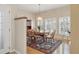 Charming dining room boasting hardwood floors, large windows, and a stylish chandelier at 4416 Calle Serena, Sarasota, FL 34238