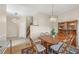 Bright dining area features hardwood floors, chandelier, and stairs to the second floor at 4416 Calle Serena, Sarasota, FL 34238