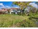 The rear of this two-story home has a red tile roof and faces the yard at 4416 Calle Serena, Sarasota, FL 34238