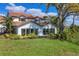 A beautiful home with a red tile roof, white walls, and lots of windows at 4416 Calle Serena, Sarasota, FL 34238