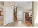 Inviting foyer with tile flooring, chandelier, staircase, and a glimpse of the dining area at 4416 Calle Serena, Sarasota, FL 34238