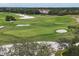 Scenic golf course with beautiful greens and sand traps nestled between mature trees in an exclusive neighborhood at 4416 Calle Serena, Sarasota, FL 34238