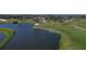 Scenic golf course with lake and lush green grass, perfect for a relaxing game at 4416 Calle Serena, Sarasota, FL 34238