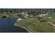 Scenic golf course with a lake and golfers, perfect for enjoying the outdoors at 4416 Calle Serena, Sarasota, FL 34238