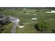 Aerial of a lush green golf course showing tee boxes, sand traps, and winding cart paths at 4416 Calle Serena, Sarasota, FL 34238