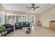 Cozy living room with modern furniture, large windows, and a ceiling fan at 4416 Calle Serena, Sarasota, FL 34238