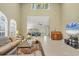 Open living room with high ceilings, ample seating, large windows, and a view of the loft area at 4416 Calle Serena, Sarasota, FL 34238