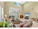 Bright living room features high ceilings, tile floors, neutral walls, and comfortable seating arrangement at 4416 Calle Serena, Sarasota, FL 34238