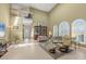 Bright, open living room with high ceilings, large windows, tile flooring, and comfortable seating arrangement at 4416 Calle Serena, Sarasota, FL 34238