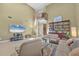 Comfortable living room featuring a bookshelf, sofas, and a two-story vaulted ceiling at 4416 Calle Serena, Sarasota, FL 34238