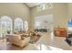 Spacious living room with high ceilings, large windows, and tile flooring with lots of natural light at 4416 Calle Serena, Sarasota, FL 34238