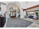 Elegant lobby with stone floors, chandelier, and comfortable seating area at 4416 Calle Serena, Sarasota, FL 34238