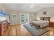 Bright main bedroom with french doors, ensuite bathroom, and hardwood floors at 4416 Calle Serena, Sarasota, FL 34238