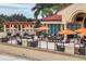 Scenic outdoor patio with comfortable seating, cozy fireplaces, and vibrant orange umbrellas for shade at 4416 Calle Serena, Sarasota, FL 34238