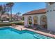 Community pool area with ample seating, a covered lounge area, well-kept landscaping, and multiple residential buildings at 4416 Calle Serena, Sarasota, FL 34238
