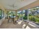 This beautiful sunroom features floor-to-ceiling windows and a great view of the lawn at 4416 Calle Serena, Sarasota, FL 34238