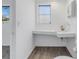 Bright bathroom with a unique sink, window, and modern fixtures at 4461 Maceachen Blvd, Sarasota, FL 34233