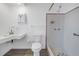 Bathroom with a tiled shower, unique sink, and white fixtures at 4461 Maceachen Blvd, Sarasota, FL 34233