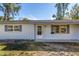 Single-story home with a modern exterior, featuring well-maintained landscaping and inviting entrance at 4461 Maceachen Blvd, Sarasota, FL 34233