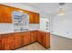Kitchen with white countertop and wood cabinets featuring a window to the backyard at 4461 Maceachen Blvd, Sarasota, FL 34233