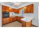 Kitchen featuring wood cabinets, built-in appliances, and a ceiling fan at 4461 Maceachen Blvd, Sarasota, FL 34233