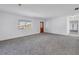 Carpeted living room featuring multiple windows and a wood-framed glass door at 4461 Maceachen Blvd, Sarasota, FL 34233