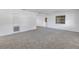 Open-concept living room with neutral gray carpet, a window and access to other rooms at 4461 Maceachen Blvd, Sarasota, FL 34233