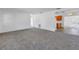 Spacious living room with neutral gray carpet, access to a kitchen and other rooms at 4461 Maceachen Blvd, Sarasota, FL 34233