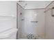 Close-up of a tiled shower with grab bars and a handheld showerhead at 4461 Maceachen Blvd, Sarasota, FL 34233