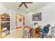 Well-lit office with ceiling fan, sewing table, and view to a doorway, hallway and parts of the foyer at 4610 Royal Dornoch Cir, Bradenton, FL 34211